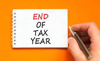 End of tax year symbol. Concept words phrase End of tax year on beautiful white note. Businessman's...