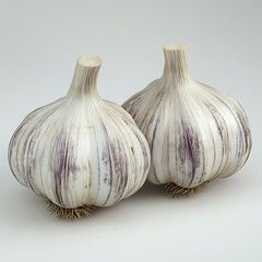 Obraz premium Two heads of fresh purple garlic displayed with a bright clean and high resolution photo.