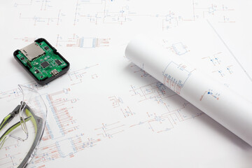 Electronic circuit board with schematic drawings and safety glasses
