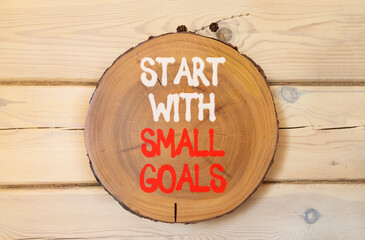 Start with small goals symbol. Concept words phrase Start with small goals on beautiful wooden...