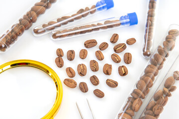 Scientific analysis of coffee beans with test tubes, magnifying glass, and tweezers on a white background.