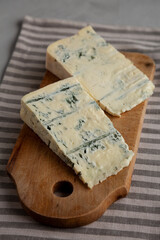 Blue cheese Gorgonzola on a Wooden Board, side view.