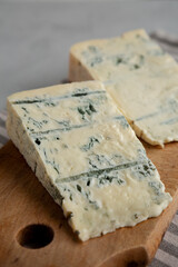 Blue cheese Gorgonzola on a Wooden Board, side view.