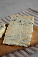 Blue cheese Gorgonzola on a Wooden Board, side view.