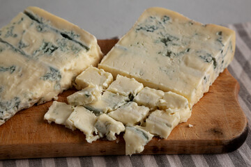 Blue cheese Gorgonzola on a Wooden Board, side view. Close-up.