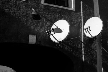 Satellite dishes on wall of an old building	