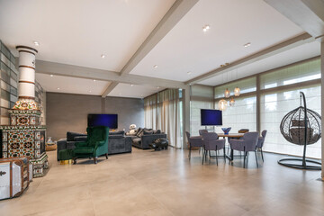 The interior of the living room with a modern design. Fireplace decorated with patterned tiles and stylized retro.