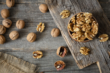 Ripe and fresh walnut kernels in bowl without shell on rustic table, healthy nut food for brain