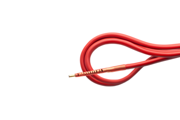 A close up of a coiled red cable with a metallic end against a black background in a studio shot