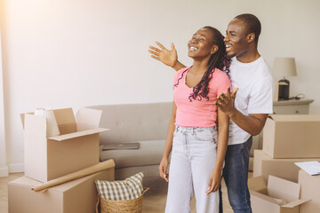 Happy African American Couple Moving into New Apartment, Man Covering Woman's Eyes, Making Surprise
