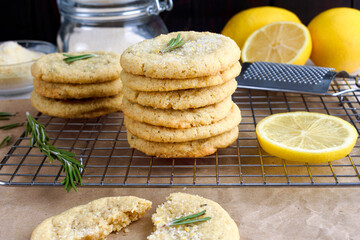 Rosemary-Lemon Sugar Cookies Stacked on a Wire Rack: Side view of stacked of freshly baked homemade sugar cookies on a wire cooling rack