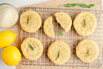 Rosemary-Lemon Sugar Cookies Cooling on a Wire Rack: Directly above half a dozen freshly baked homemade sugar cookies on a wire cooling rack