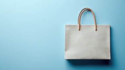 Plain light beige paper shopping bag on a light blue background