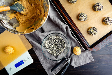 Balls of Cookie Dough Rolled in Sesame Seeds: Cookie dough, white and black sesame seeds, cookie...
