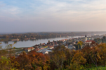 Fototapeta premium An aerial view of the village of Batina in Slavonia, Croatia, with the Danube River marking the border with Hungary and Serbia, all under a morning light.