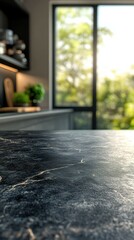 Black marble kitchen countertop with sunlight streaming through large windows in a modern home setting