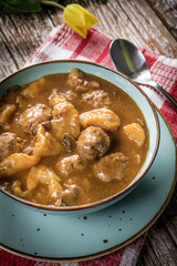 Meatballs in gravy with cast noodles.