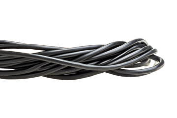 A close up view of tangled black electrical cords against a black background in a horizontal orientation