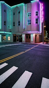 B&acirc;timent art d&eacute;co &eacute;clair&eacute; par des lumi&egrave;res pastel la nuit dans une rue vide

