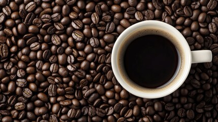 Fototapeta premium View from top of black coffee in white cup with beans. Close-up with space for text.