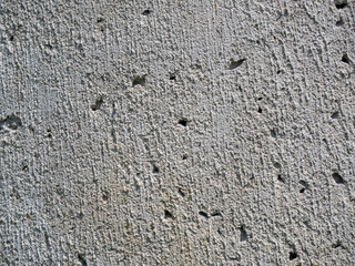 Rugged concrete texture with pitted surface for construction or architectural designs.