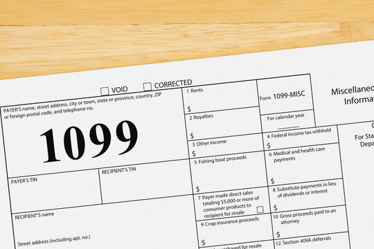 Federal tax 1099 form on a wood desk