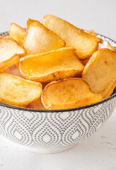 Golden potato dippers served hot in bowl, crispy edges and rustic feel