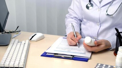 Hands of male doctor writing prescription on paper, working on Keeping your - Powered by Adobe