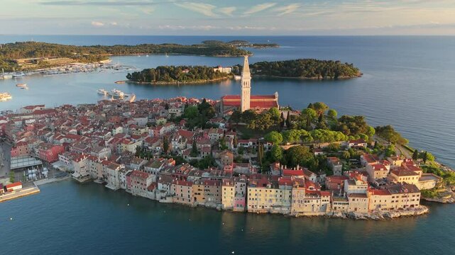 Aerial view of stunning coastline of Rovinj during golden hour. Sunset view of the Rovinj old town, famous ancient Croatian city at the Adriatic sea, Istria peninsula, Croatia