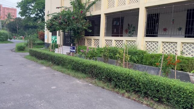 Ground-Level View of Institutional Building Veranda and Manicured Garden Bed