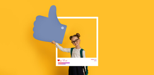 A young girl, wearing glasses and twin buns, enthusiastically holds a large thumbs up sign. The vibrant yellow background and social media frame create a lively atmosphere perfect for online content.
