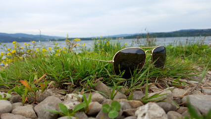 sunglasses on the lake beach.