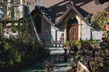 Doves resting on the tiled roof of a traditional stone church in Platanistasa, a picturesque village nestled in the Troodos