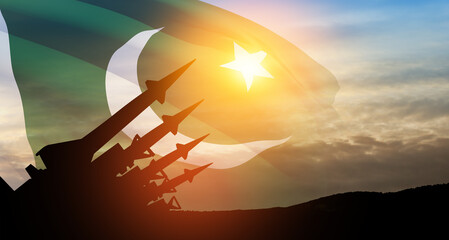 The missiles are aimed at the sky at sunset with Pakistan flag. Nuclear bomb, chemical weapons, missile defense.