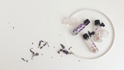 Tranquil spa still life with floral oils lavender and healing crystals for relaxation and self care