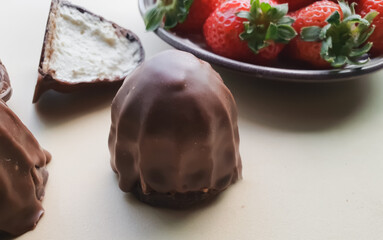 chocolate covered marshmallow isolated and vertical photo and blurred beige background
