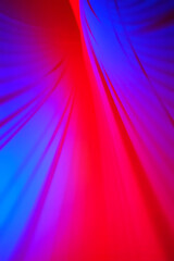 Abstract flowing fabric design with vibrant red and blue colors creating a dynamic feel
