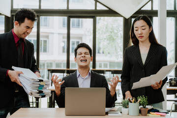 Overwhelmed Businessman with Stressful Colleagues