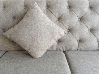 Pillows placed on a gray sofa background with luxury pattern with empty space for text.