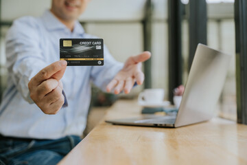 Man Holding Credit Card for Online Payment
