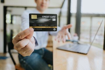 Man Holding Credit Card for Online Payment