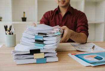 Man Holding Stack of Documents in Office