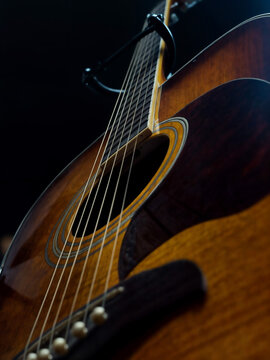Close-Up of Acoustic Guitar with Strings: Moody Lighting on Instrument	