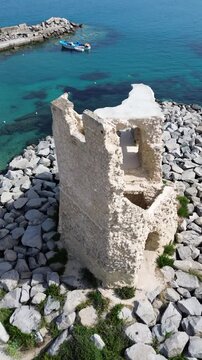 Ascending drone shot of the La Rocchetta in Briatico coastal town in Calabria, Italy on a sunny day