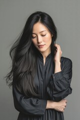 A woman with long black hair wearing a black shirt