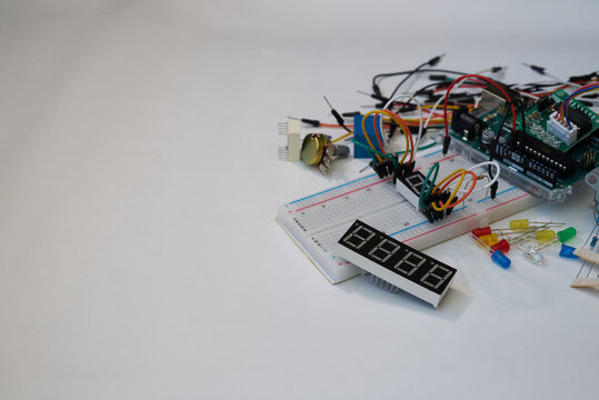 Assorted electronic components and microcontroller on breadboard with wires and LEDs