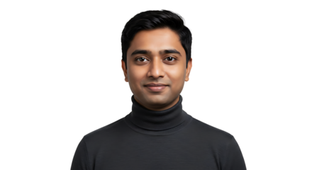 A friendly, smiling Indian man poses for a studio portrait with a black background.