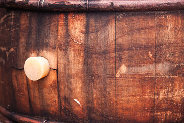 A wooden barrel with a cork inserted into it.