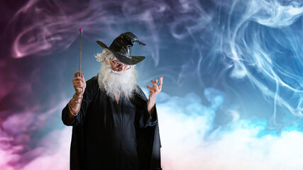 Wizard old man casting spell with magic wand