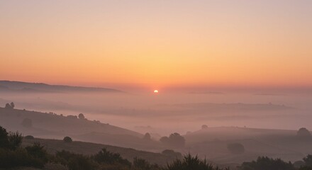 Obraz premium Serene Sunrise Over Misty Valley Landscape Breathtaking Dawn Scenery